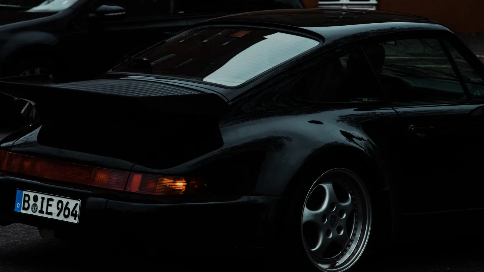 Porsche 964 rear quarter on a Berlin street at night