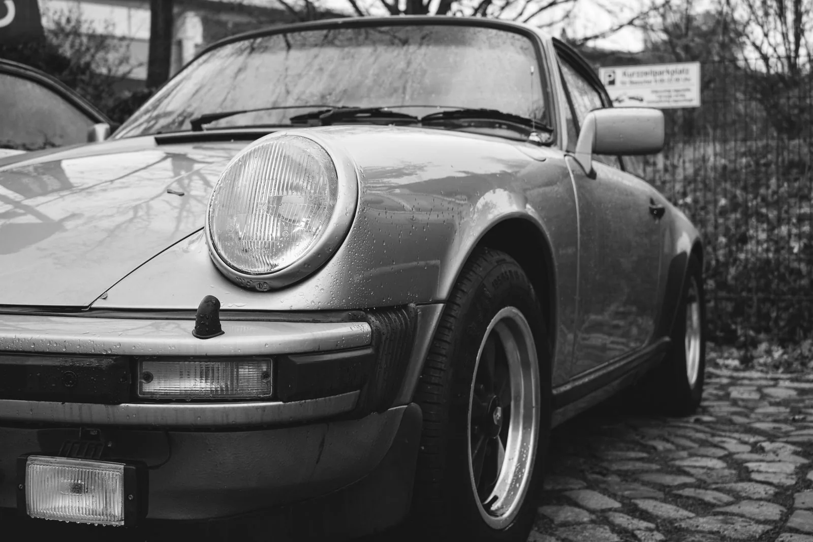 Rain-speckled 911 Targa on Berlin cobblestone