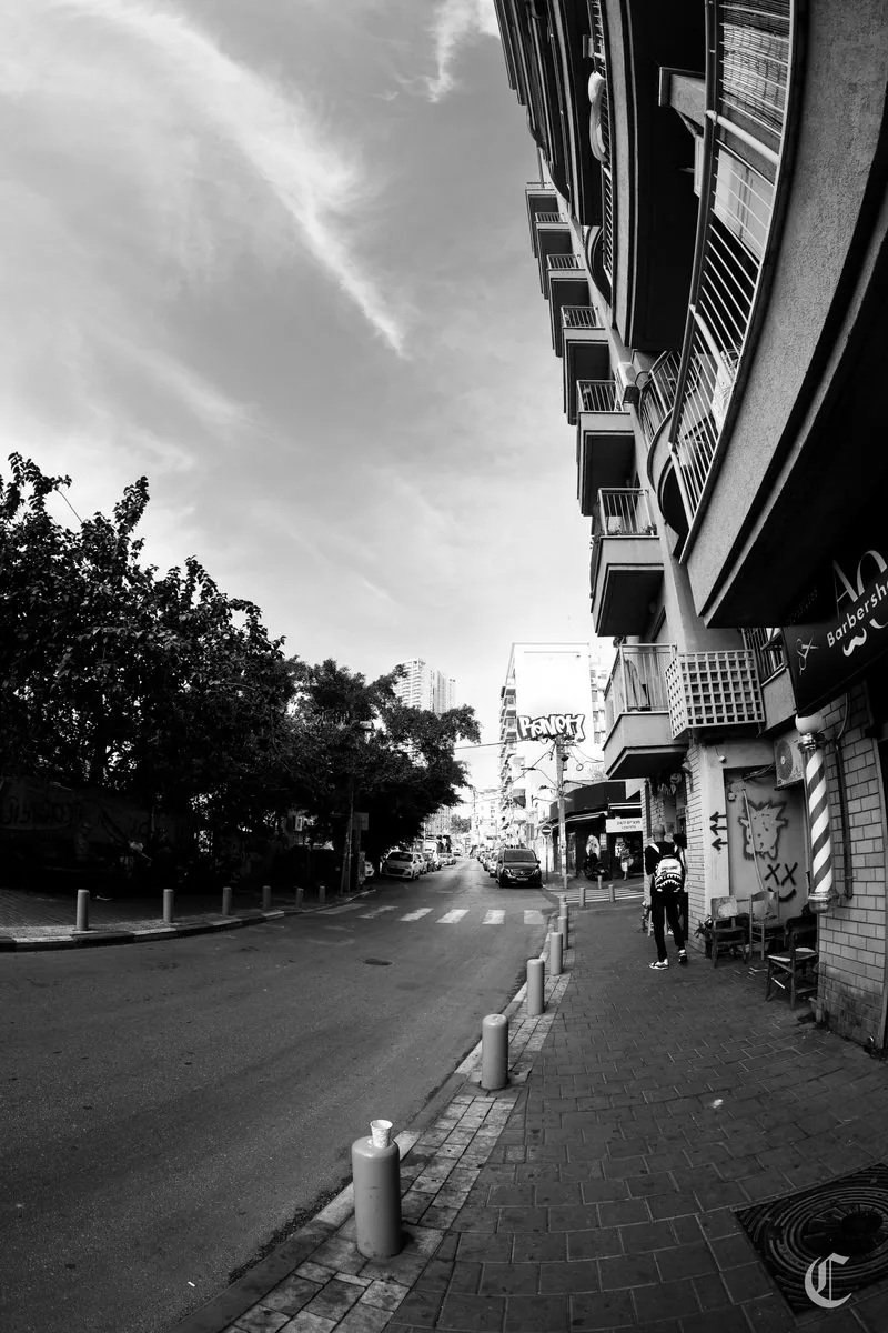 Side street, barbershop pole, lone figure