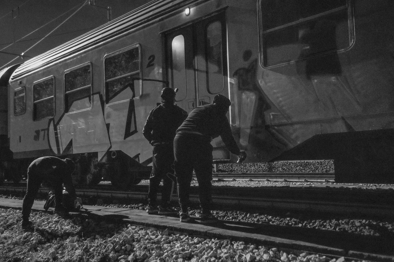 Writers painting by the train's interior light